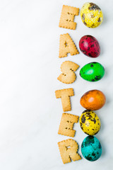 Color quail eggs with text on the table
