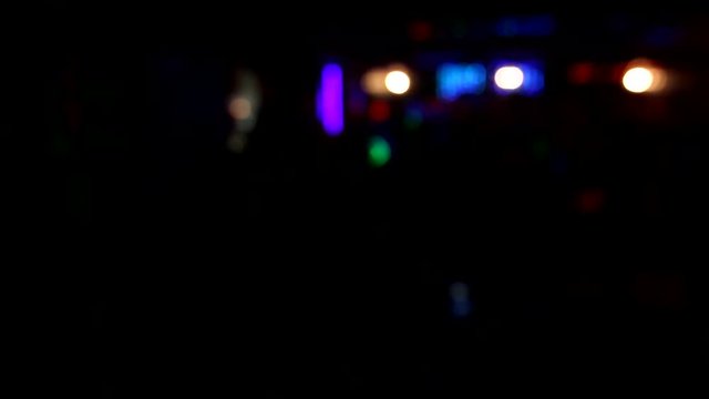Girl dancing on stage on blurred background in the night club