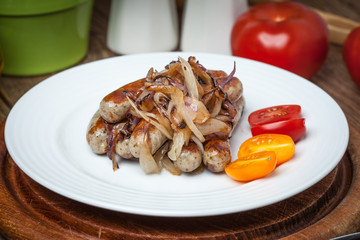 Fried Fried white sausages with onion on the plate.white sausage