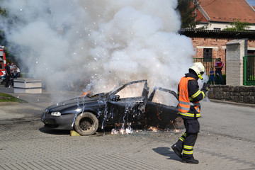 Car in fire, fireman  practice explosion