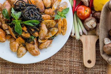 Seafood pasta with clams Black Spaghetti Vongole on white plate