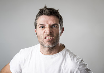 Obraz premium young attractive man with blue eyes looking angry and mad in rage emotion and upset
