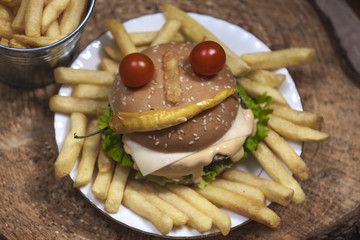 Fresh french fries, chips with tasty happy burger background