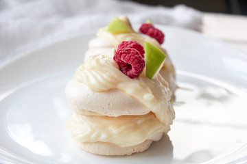 Pavlova meringue cake with custard and fresh berries