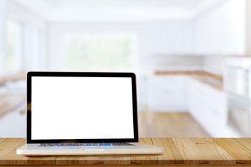 Fototapeta premium Smart Display Concept. Mock up laptop on wood table in modern kitchen room. for product montage display.