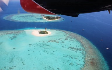 Fototapeta na wymiar Maafushivaru e Lonubo twin island, aerial view from seaplane. Ari Atoll, Maldives