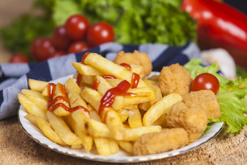 Fresh french fries, chips with tasty chicken nuggets