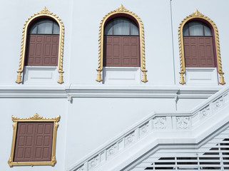 Many Windows Thai temple and Upstair on white wall in Summer.