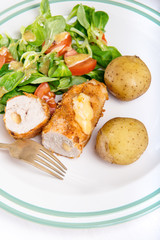 Kiev cutlet with jacket potatoes and salad