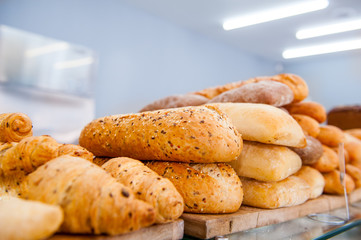 Various kinds of bread on display in bakery shop. Selective focus