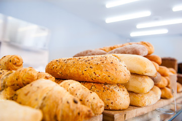 Various kinds of bread on display in bakery shop. Selective focus