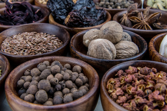 Whole Nutmeg and Other Spices in Bowls