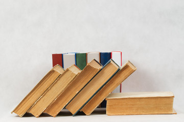 Stack of hardback books on wooden table. Back to school.