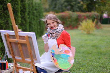 Women beautiful painter posing and smiling, laughing into camera