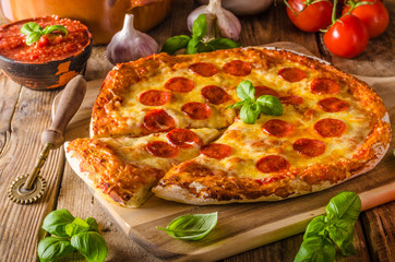 Homemade cheese pizza with salami