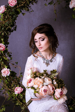 Beauty Portrait of bride wearing in wedding dress with voluminous skirt, studio photo