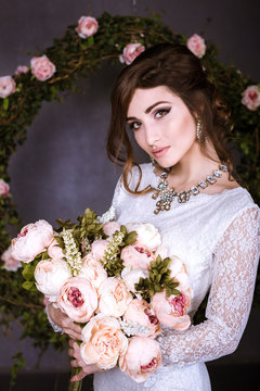 Beauty Portrait of bride wearing in wedding dress with voluminous skirt, studio photo