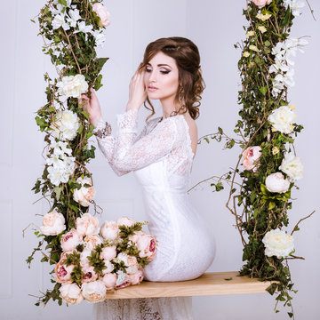 Beauty Portrait of bride wearing in wedding dress with voluminous skirt, studio photo