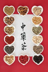 Chinese herbal tea selection in heart shaped bowls with calligraphy on rice paper. Translation reads as chinese herb tea. Used also in herbal medicine,