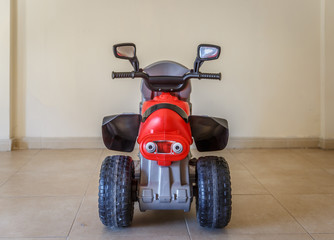 View from behind of a toy motorcycle, in the living room of a ho