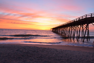 Sunrise over the pier in Kure Beach North Carolina