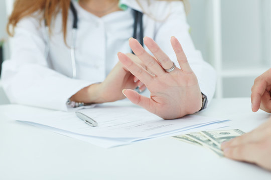 Female medicine doctors holding a clipboard with a blank sheet of paper closeup. Medical help or insurance concept. Doctor is waiting for patient to examine.