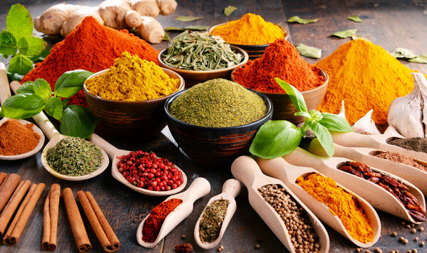 Fototapeta Variety of spices and herbs on kitchen table