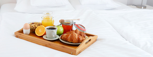 Obraz na płótnie Canvas Breakfast in bed in hotel room.