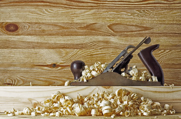 Plane in the chip on the background of wooden wall