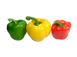 Three ripe vibrant color bell peppers, green, yellow and red with green stem isolated on white...