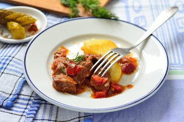 Beef goulash with sauce and potatoes