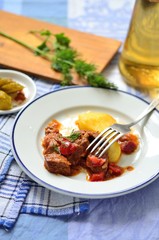 Beef goulash with sauce and potatoes