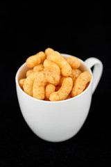 Flips snack in the white mug on black background