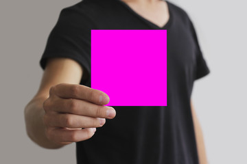 Man showing blank pink square flyer brochure booklet. Leaflet pr