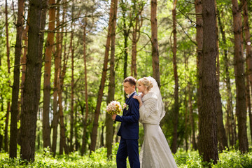 Wedding day, bride and groom in forest