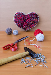 Tools for handiwork in stile String Art on wooden table
