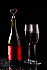 Bottle of wine with a cork in the form of heart and two glasses.