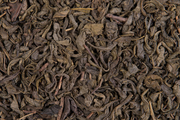 Dry green tea leaves background texture