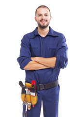 Portrait of a young worker smiling with arms crossed, isolated o - obrazy, fototapety, plakaty