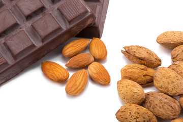 Almonds and dark chocolate isolated on white background.