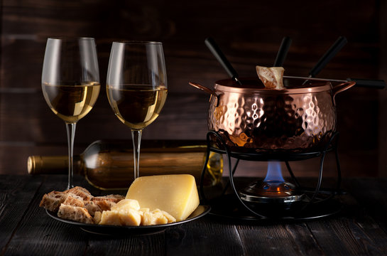 Swiss  cheese fondue on rustic background