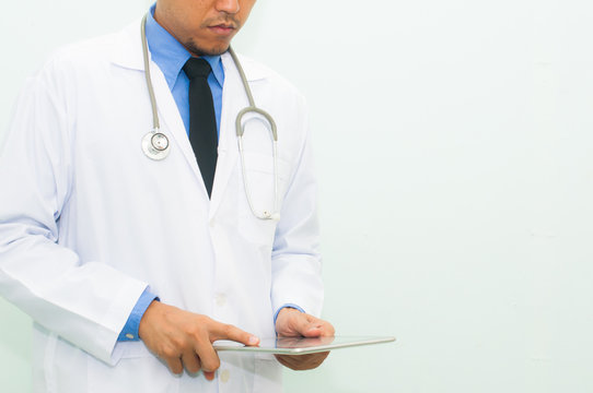 Doctor working with his digital tablet