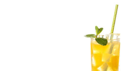 Glass of cold refreshing orange drink with ice and mint
