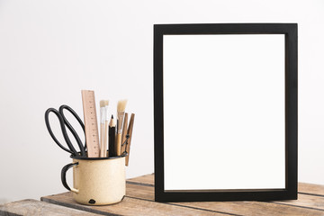 Black frame and school supplies.