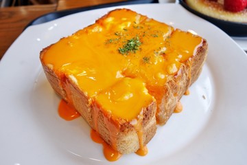homemade  cheese toast on White Dish