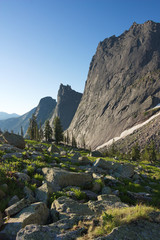 the stony valley against the background of three mountains in Sayan Mountains