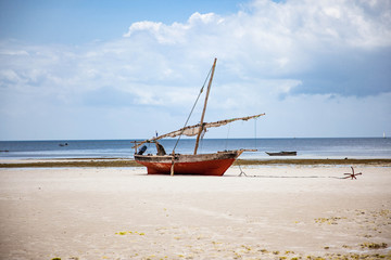 Традиционная рыбацкая лодка Доу на берегу, остров Занзибар.