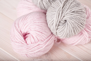 balls of wool pink and gray thread