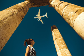 Young woman look at airplane dreaming about vacation. Explore the world. Export concept. Time to travel. Freedom life. Independent person. Tourism and transportation industry. Spirit of adventure.