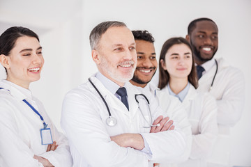 Cheerful team of doctors standing together